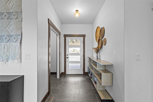 Entryway featuring stone tile floors and baseboards | Image 31
