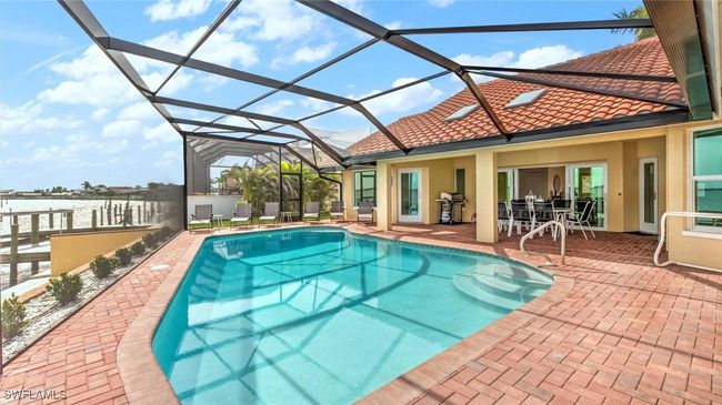 Swimming pool with grilling area, a patio area, and glass enclosure | Image 4