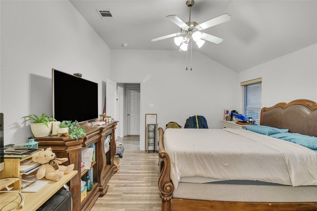 Bedroom with lofted ceiling, light wood-style floors, and ceiling fan | Image 18