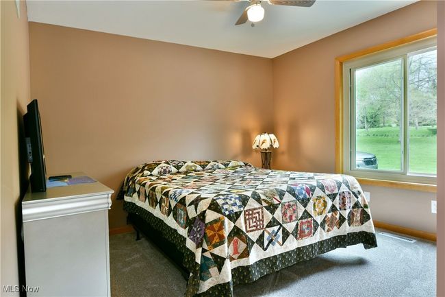 Bedroom featuring carpet flooring, multiple windows, and baseboards | Image 16