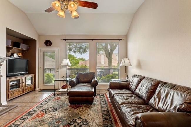 Living room with lofted ceiling, ceiling fan, and tile patterned flooring | Image 19