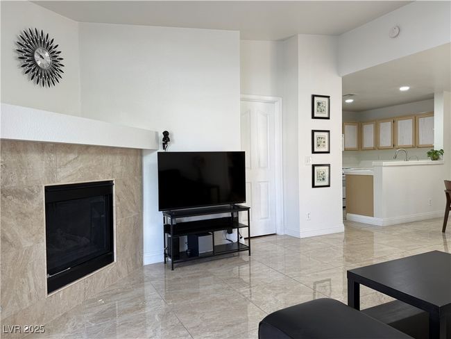Living room with recessed lighting, a tile fireplace, marble finish floor, and baseboards | Image 5