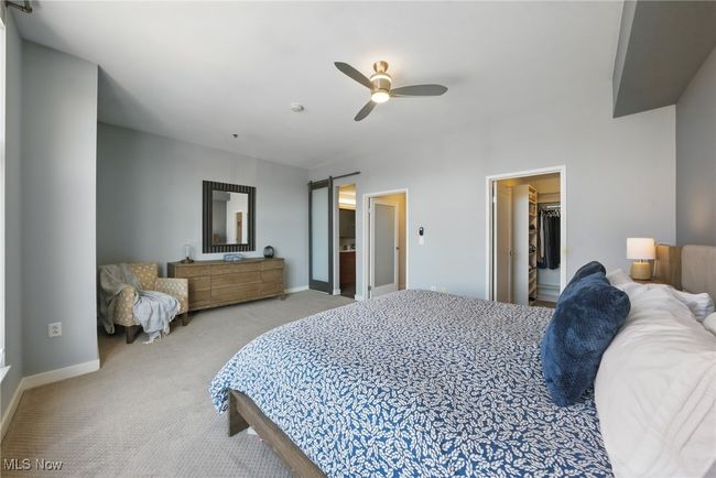 Carpeted bedroom featuring a walk in closet, baseboards, and ceiling fan | Image 21