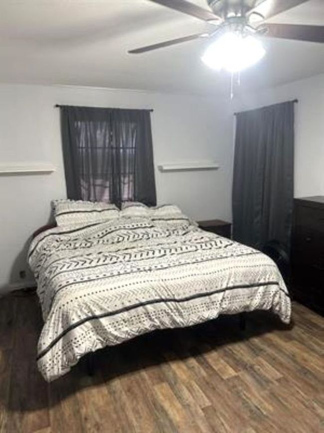 Bedroom featuring wood finished floors and a ceiling fan | Image 11