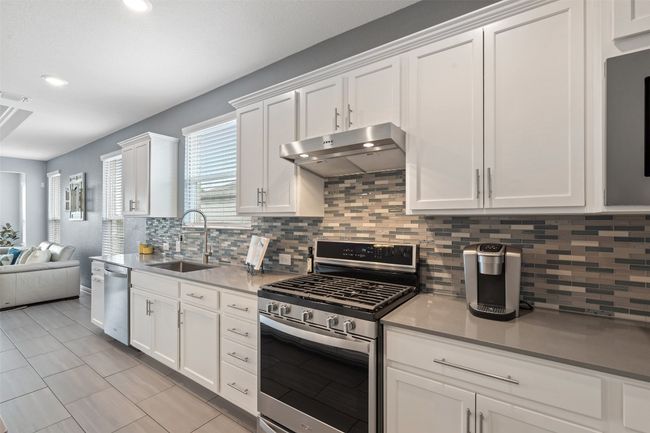 Kitchen with stainless steel appliances and gas cooktop. | Image 13