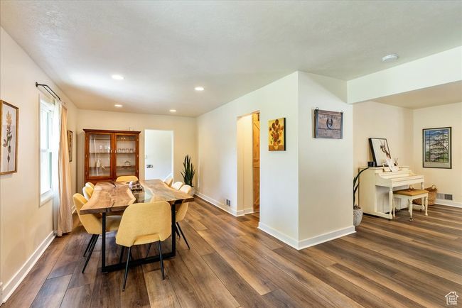 Dining space with dark wood finished floors and recessed lighting | Image 22
