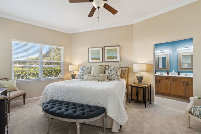 Main-level retreat with plush carpeting and serene views. | Image 14