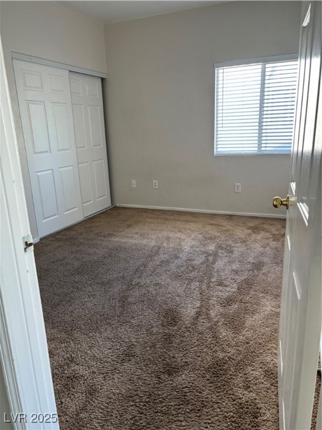 Unfurnished bedroom with carpet floors, a closet, and baseboards | Image 5