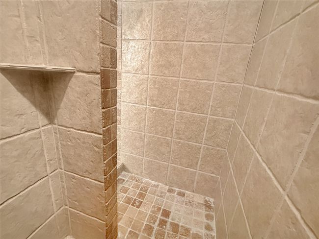 Bathroom view of a tile shower | Image 11