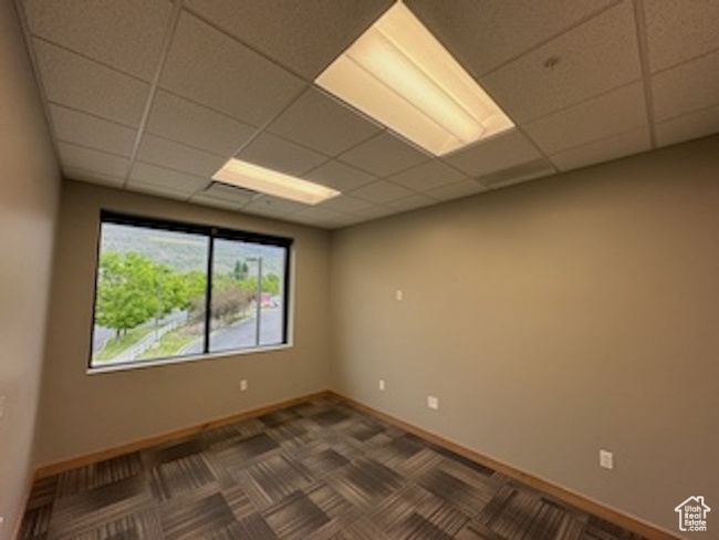 Empty room with a paneled ceiling | Image 25
