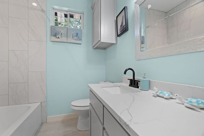 Bathroom featuring vanity and bathing tub / shower combination | Image 31