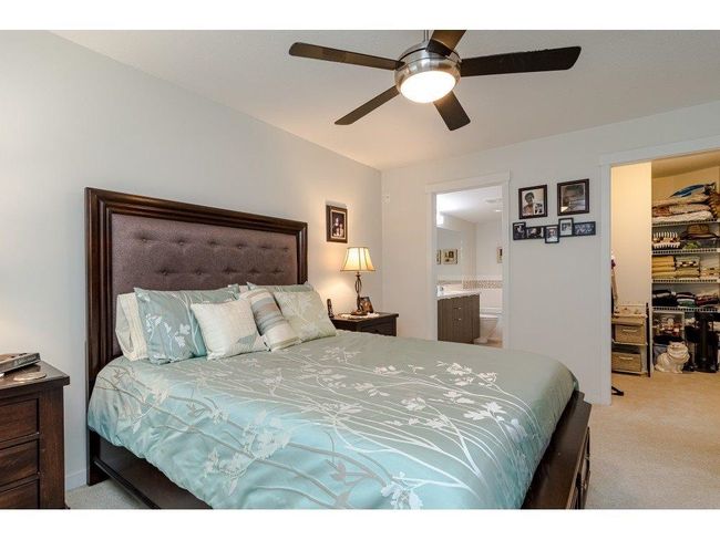 Bedroom with a walk in closet, a ceiling fan, carpet flooring, and ensuite bathroom | Image 11
