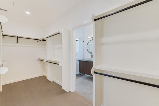 Spacious closet featuring light wood-style floors and a sink | Image 20