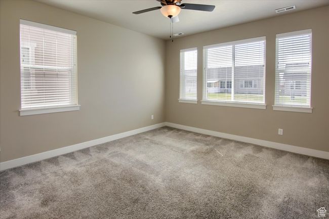 Unfurnished room with visible vents, ceiling fan, baseboards, and carpet | Image 13