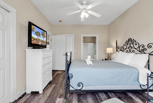 Bedroom featuring ceiling fan, baseboards, and dark wood-style floors | Image 20