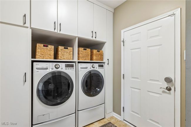 Nice size laundry room with built-in cabinetry and storage | Image 17