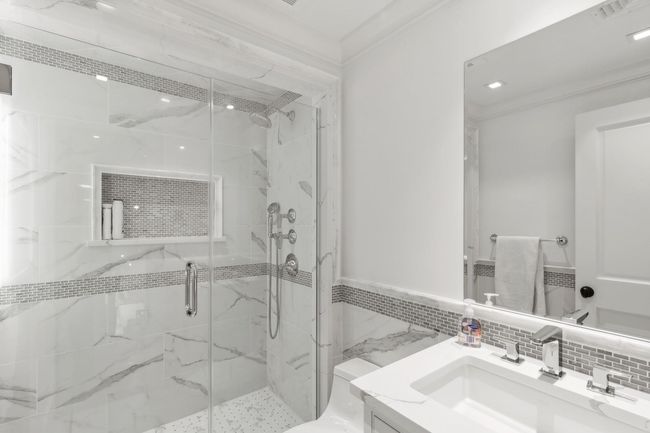 Bathroom featuring backsplash, vanity, ornamental molding, and walk in shower | Image 35