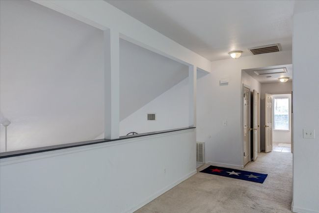 Upstairs hall looking from the loft/game room/2nd living area down the hall toward the other 3 bedrooms. | Image 15