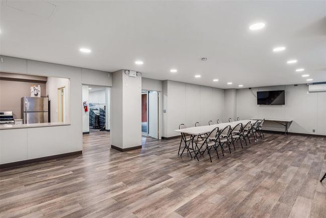 Dining area with a wall mounted AC, wood finished floors, and recessed lighting | Image 17