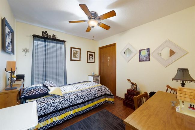 Bedroom featuring ceiling fan and wood finished floors | Image 24