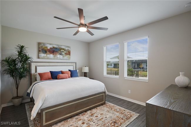 Bedroom featuring ceiling fan, baseboards, and dark wood finished floors | Image 9