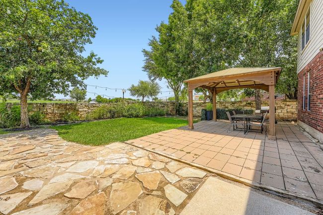 Fenced backyard with a gazebo, a patio, and outdoor dining area | Image 31