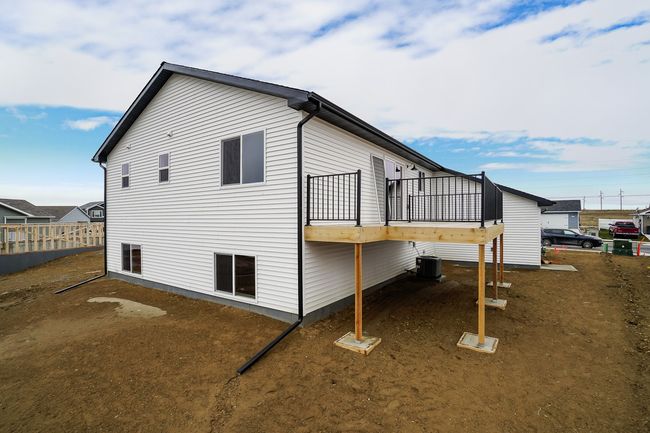 View of side of home featuring fence, central AC, and a wooden deck | Image 17