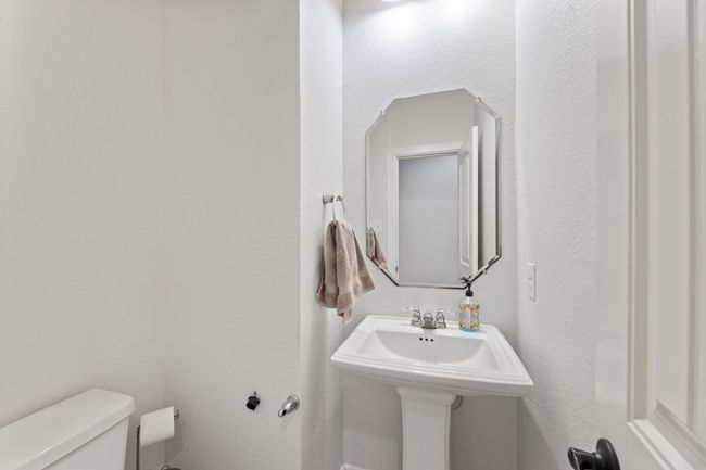 Half bathroom featuring toilet and a sink | Image 17