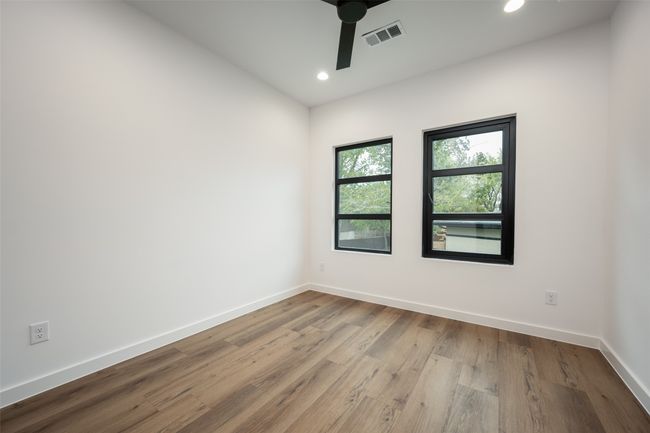 Empty room with ceiling fan, recessed lighting, and wood finished floors | Image 28
