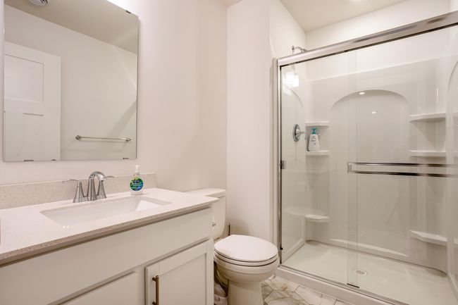 Modern bathroom featuring a glass-enclosed shower, updated fixtures, and elegant tilework. | Image 39