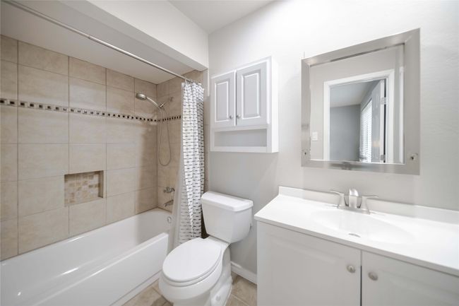 Full bath featuring vanity and shower / bathtub combination with curtain | Image 24