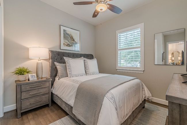 Bedroom with wood finished floors, baseboards, and ceiling fan | Image 19
