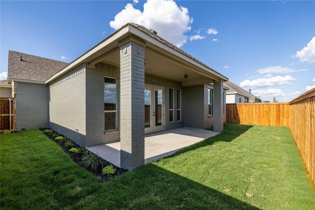 Rear view of house with brick siding, a patio, and a fenced backyard | Image 29