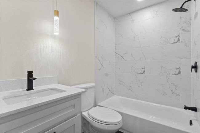Bathroom featuring shower / tub combination and vanity | Image 12