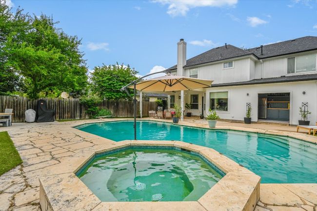 View of pool featuring a patio, a fenced backyard, and a pool with connected hot tub | Image 28