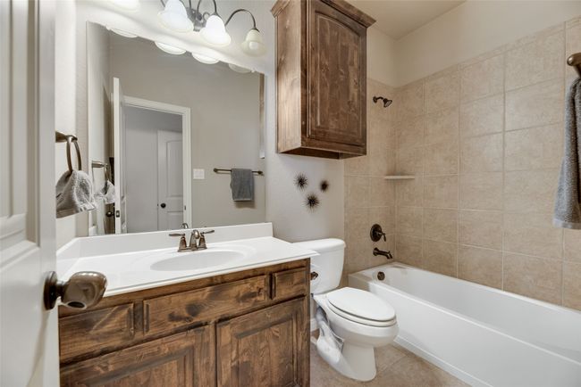 Bathroom with vanity, shower combination, and tile patterned floors | Image 28
