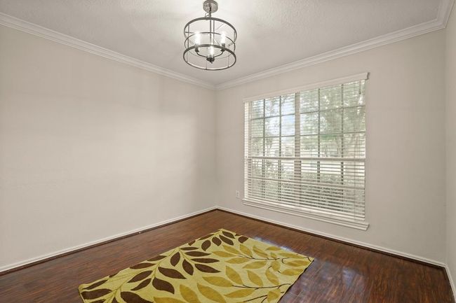 Versatile space perfect for a dining room or home office, featuring ample natural light. | Image 4