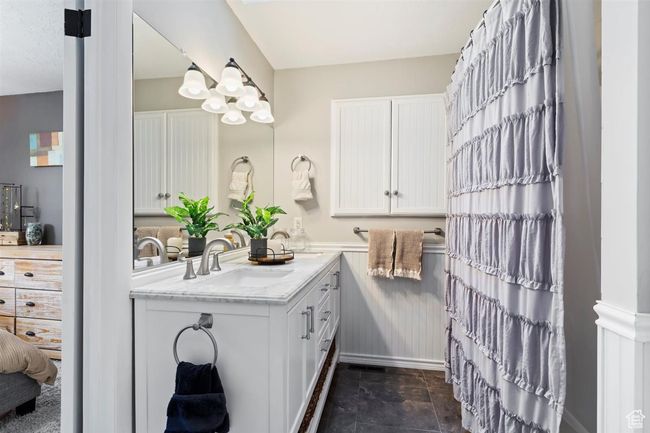 Full bathroom featuring double vanity and stone finish flooring | Image 24