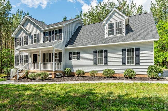 View of front facade featuring covered porch, a front yard, and a shingled roof | Image 31