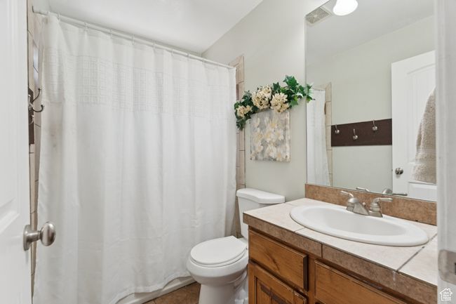 Full bath featuring toilet, vanity, and a shower with shower curtain | Image 34