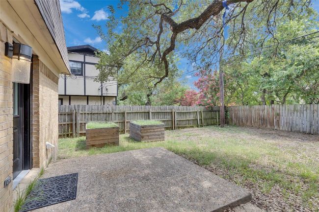 Spacious backyard with raised garden beds and plenty of oak trees. | Image 11