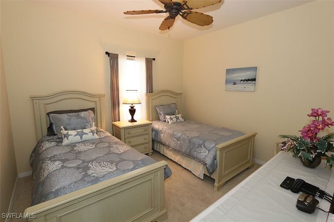 Bedroom featuring ceiling fan and light carpet | Image 16
