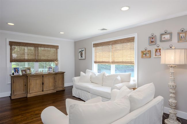 Living room with crown molding, dark wood-style flooring, and recessed lighting | Image 18