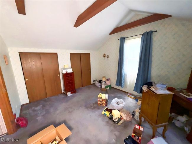 Carpeted bedroom with lofted ceiling and multiple closets | Image 23