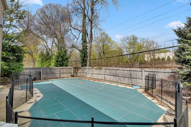 View of swimming pool featuring a fenced backyard | Image 10