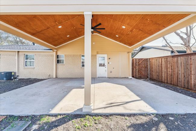 View of patio / terrace featuring an attached carport, central AC unit, fence, and ceiling fan | Image 4