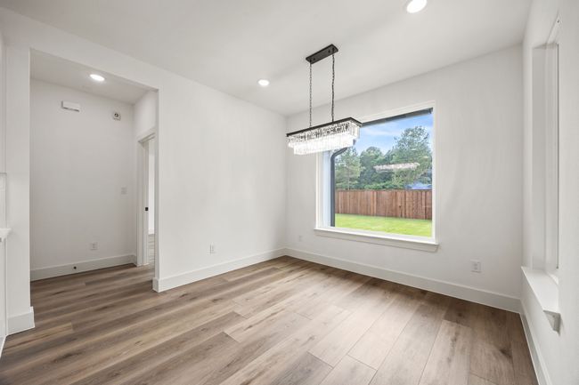 Empty room with wood finished floors, recessed lighting, and baseboards | Image 14