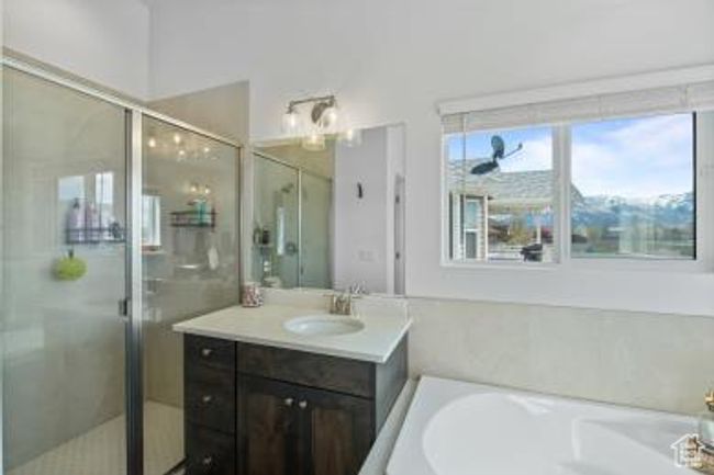 Full bath featuring a shower stall, a bath, and vanity | Image 19