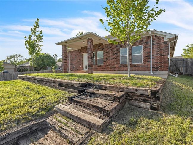 View of front of property with a front yard, fence, and brick siding | Image 19