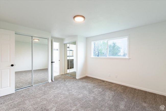 Unfurnished bedroom featuring visible vents, carpet flooring, and baseboards | Image 19